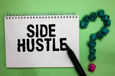 A notebook with the word "Side Hustle" written in it.